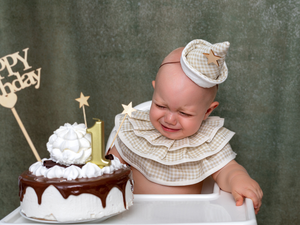 Niño con tarta de Smash Cake llorando.